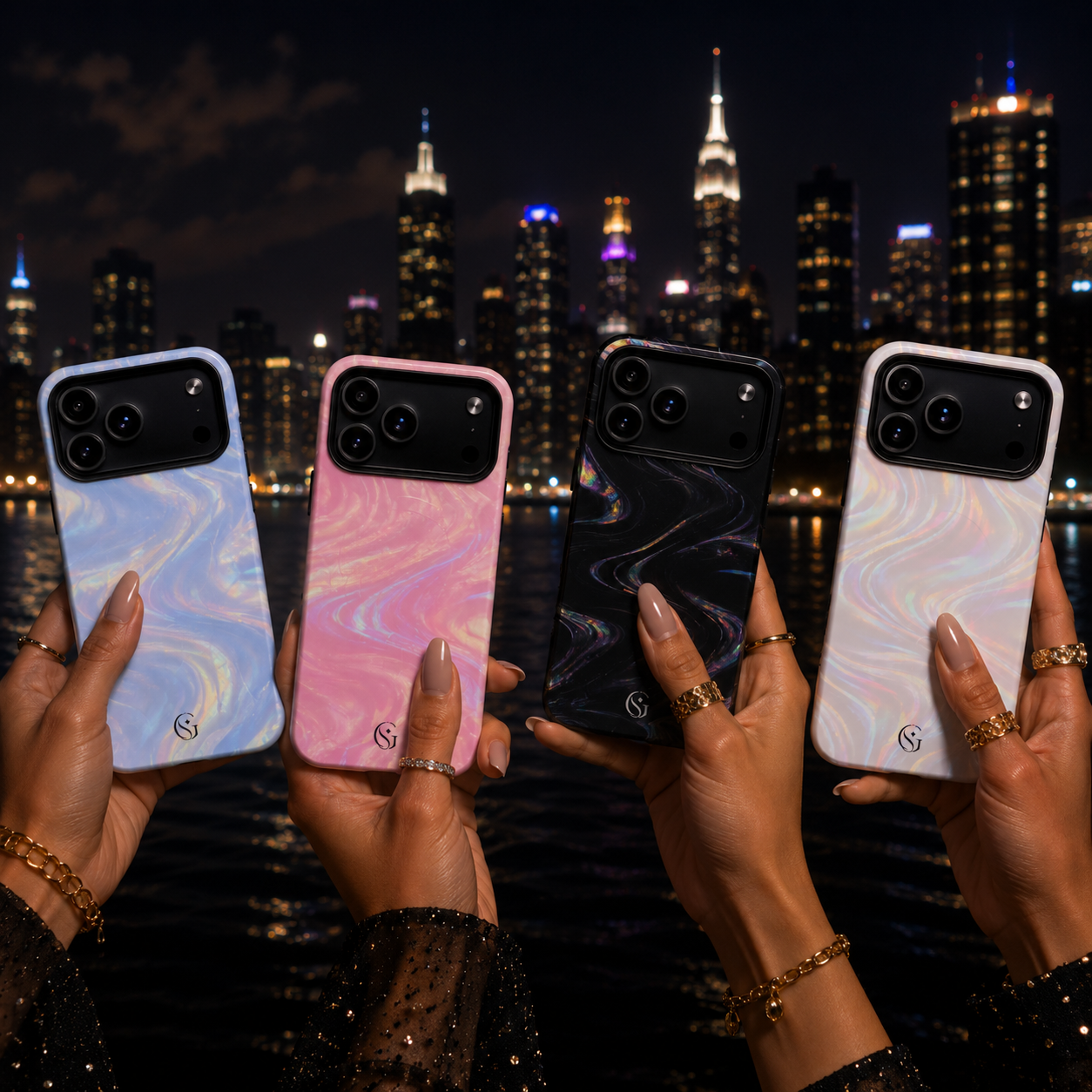 Four hands holding marble-patterned phone cases in front of a New York City skyline at night. The cases are white, pink, black, and light blue with a glossy finish and a small gold logo near the bottom, Glamsy Phone Cases